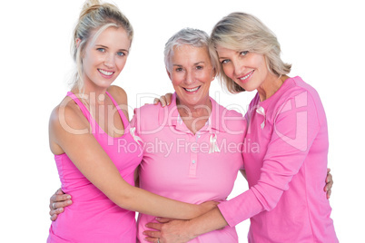 Happy women wearing pink tops and ribbons for breast cancer