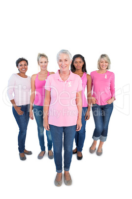 Diverse group of happy women wearing pink tops and breast cancer