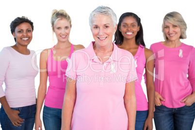 Diverse group of women wearing pink tops and breast cancer ribbo