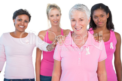 Supportive group of women wearing pink tops and breast cancer ri