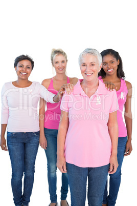 Supportive women wearing pink tops and breast cancer ribbons