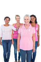 Supportive women wearing pink tops and breast cancer ribbons