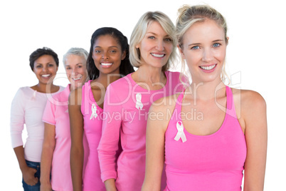 Smiling women wearing pink and ribbons for breast cancer