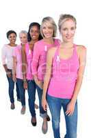 Happy women wearing pink and ribbons for breast cancer