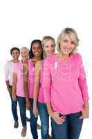 Group of women wearing pink tops and ribbons for breast cance