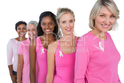 Group of diverse women wearing pink tops and ribbons for breast
