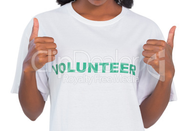 Woman wearing volunteer tshirt and giving thumbs up