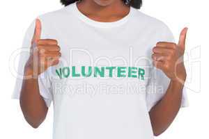 Woman wearing volunteer tshirt and giving thumbs up