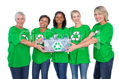 Team of happy female environmental activists holding box of recy