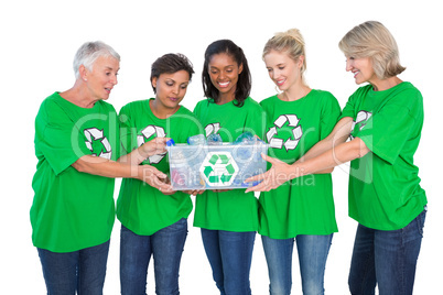 Team of female environmental activists holding box of recyclable