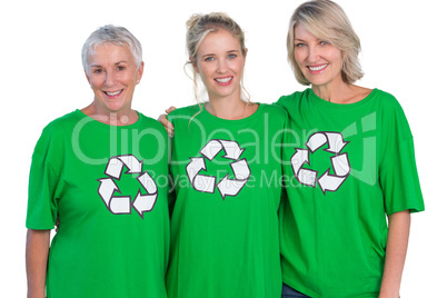 Three women wearing green recycling tshirts smiling at camera