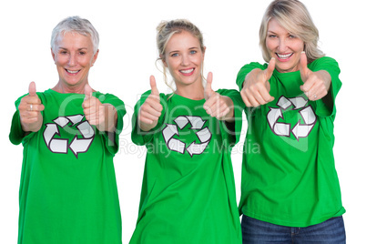 Three women wearing green recycling tshirts giving thumbs up