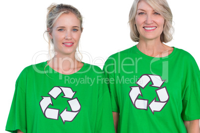 Two women wearing green recycling tshirts