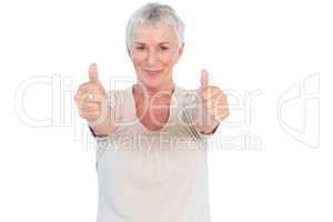 Mature woman smiling at camera giving thumbs up