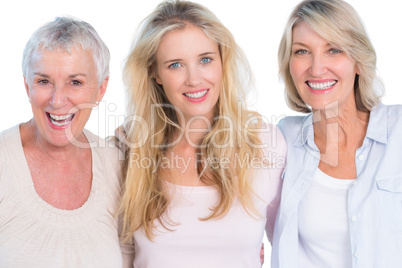 Three generations of  cheerful women smiling at camera