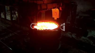Iron and Steel Works. A huge crane transports the ladle of molten metal.