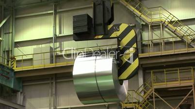 Moving of a roll of galvanized steel by electric overhead crane.
