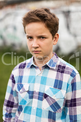 Portrait of the teenager boy in outdoors