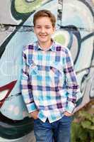 Portrait of the teenager boy in outdoors