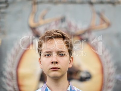 Portrait of the teenager boy in outdoors