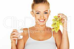 beautiful woman with grapes and water