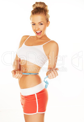 laughing woman measuring her waist