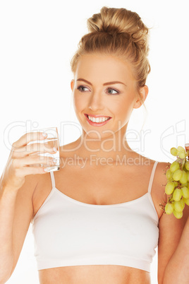 beautiful woman holding grapes and water