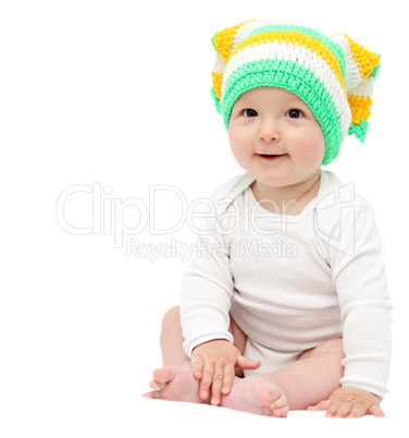 beautiful happy baby boy sitting on white bed