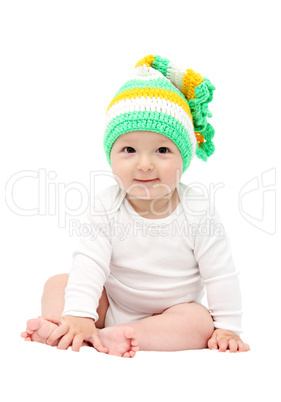 smiling baby sitting on bed