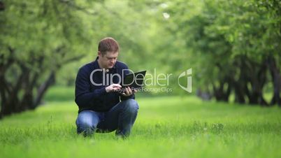 Man working with notebook in the park.