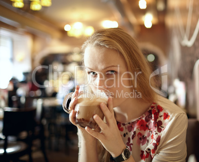 girl is drinking slat in cafe