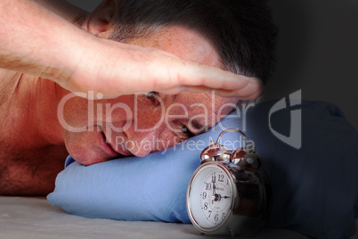 Man can not sleep and looked at the alarm clock