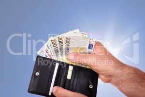 Hand with banknotes and wallet