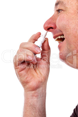 Man spraying nose drops