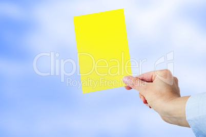 Hand shows a yellow card