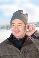Man in winter when phoning