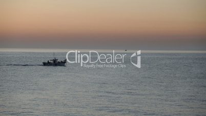 Fishing boat on sea at dawn