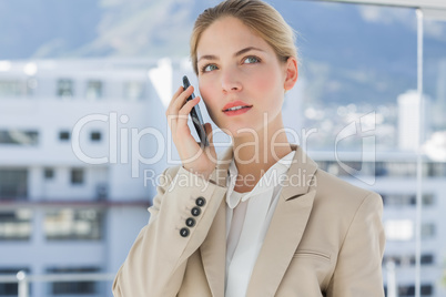 Serious businesswoman holding her phone