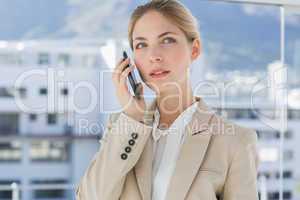 Serious businesswoman holding her phone