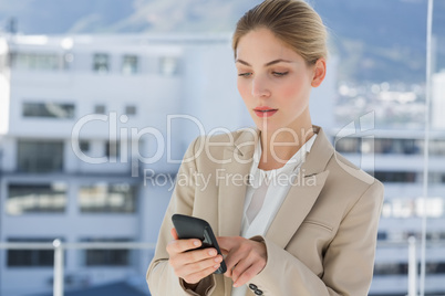Businesswoman touching the screen of her smartphone