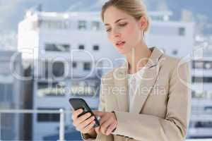 Businesswoman touching her smartphone