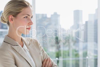 Serious businesswoman standing with arms crossed