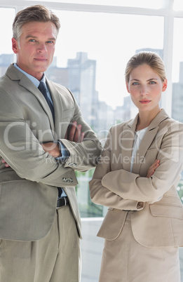 Business people standing with their arms crossed