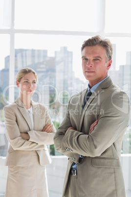 Business people standing with arms crossed