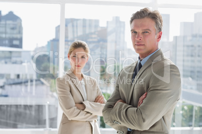 Business people standing together with arms crossed