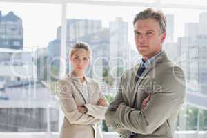 Business people standing together with arms crossed