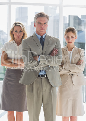 Three serious business people standing together Three serious business people standing together