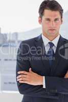 Handsome businessman standing with arms crossed
