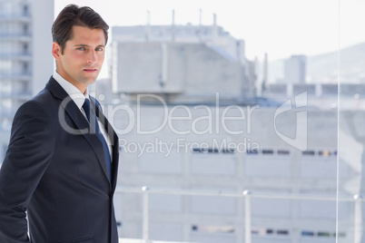 Handsome confident businessman standing