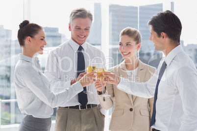 Group of business people clinking their flutes of champagne